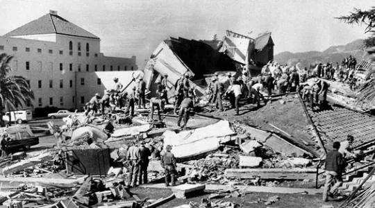 Crews asses a structurally demolished building due to the Sylmar earthquake in 1971