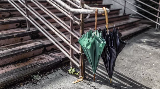 Umbrellas leaning on stair railing