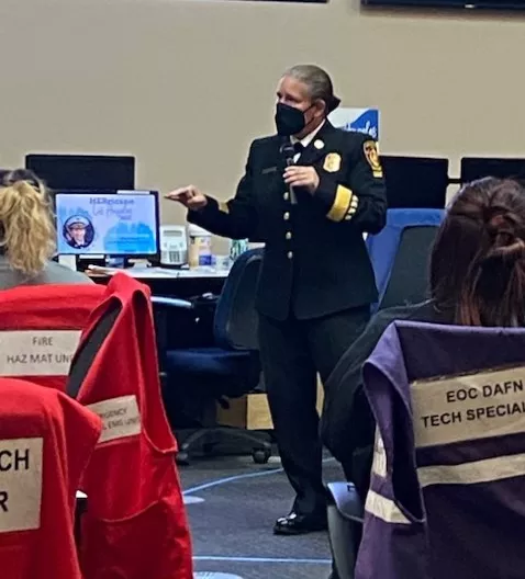 Photo of LA Fire Chief Kristin Crowley speaking to young women as part of HERricaneLA.