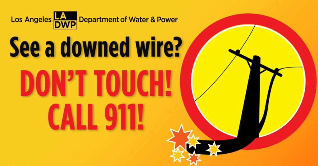 Shows image of a power pole, with sparking wires hanging from it. Text: LA Department of Water and Power -- "See a downed wire? Don't Touch; Call 911!