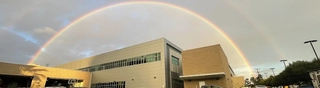 A double-rainbow sky above the LA City EOC building