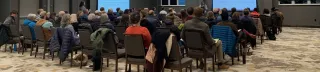 Shows a community meeting.