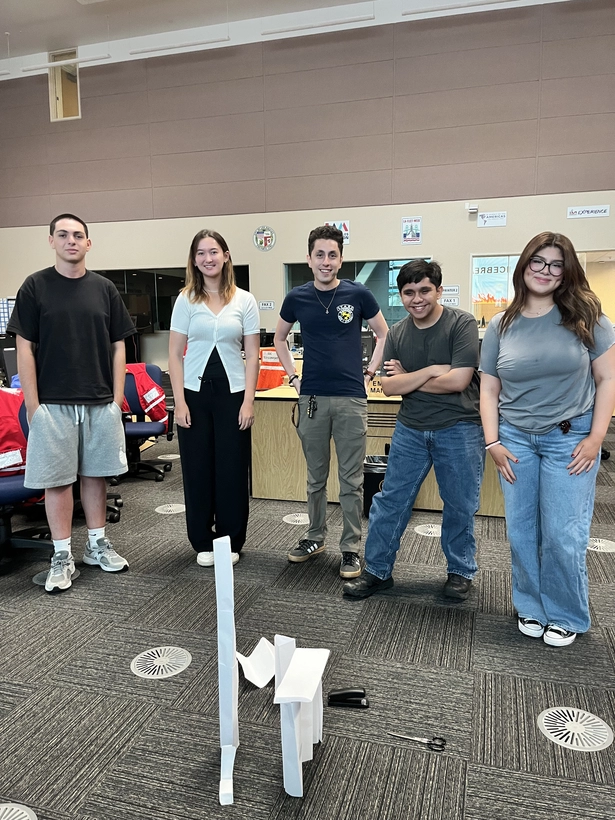 Five Camp ReadyLA participants posing next to their free standing structure made during an ice breaker activity.